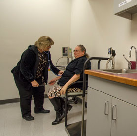 This is a nurse helping a elderly patient