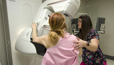 This is a picture of the staff standing by a mammography machine